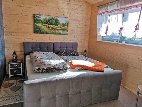 a bedroom with a bed in a wooden room at Ferienwohnung Am Roten Berg in Peiting