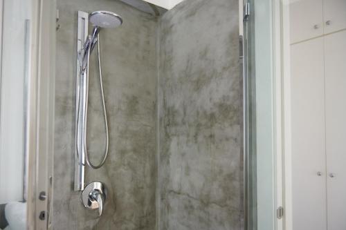 y baño con ducha con cabezal de ducha. en CefalHome - KEFAHELION, en SantʼAmbrogio