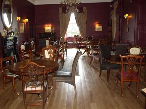 a dining room with wooden tables and chairs at The Sun Hotel in Warkworth