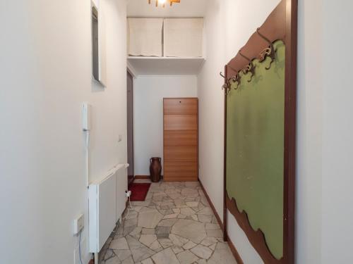 a hallway with a green door in a room at Xenia Apartments - Spacious two-room apt in the flower district in Milan