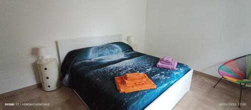 a bedroom with a blue bed with two towels on it at LoVe House - Apartment on the beach in Pescara