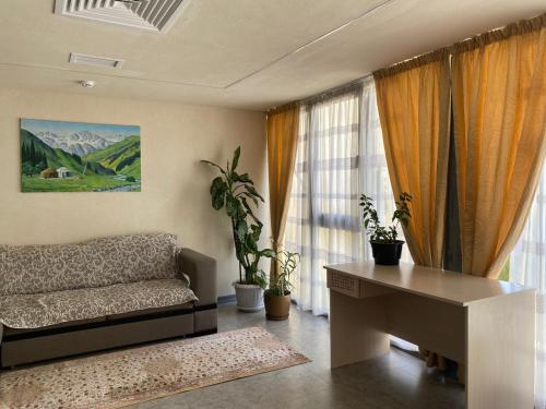 a living room with a couch and a table at AQ Capsule Hostel in Almaty