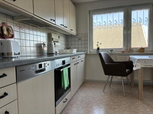 a kitchen with a stove and a chair in it at Auszeit Sembzin in Klink