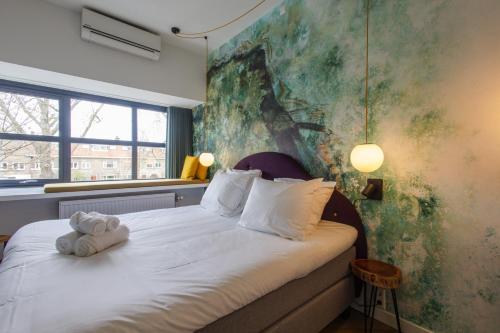 Katil atau katil-katil dalam bilik di Badhuis Hotel