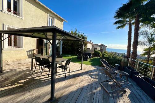 un patio avec une table et des chaises sur une terrasse dans l'établissement Golfe Juan - Villa 4 people - Sea view - Garden, à Vallauris