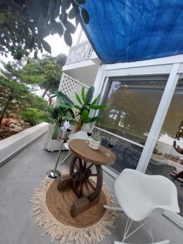 a small table and two chairs on a balcony at George's point of view in Naousa