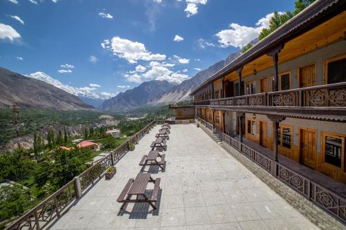 a row of benches on the balcony of a building at Roomy Daastaan Hotel, Karimabad Hunza in Hunza Valley