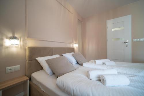 a bedroom with a bed with white pillows on it at Monako in Kłodzko