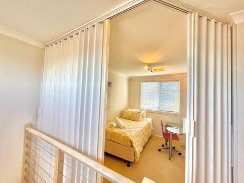 a bedroom with a bed and a window at Your Oasis in the Heart of East Perth in Perth