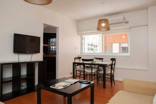 sala de estar con mesa y TV en Apartamento Canciller en Buenos Aires