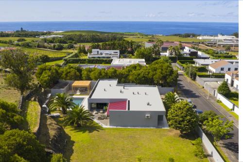 an aerial view of a house with the ocean in the background at Luxury Villa in Ribeira Grande in Ribeira Grande