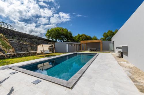 a swimming pool in the backyard of a house at Luxury Villa in Ribeira Grande in Ribeira Grande