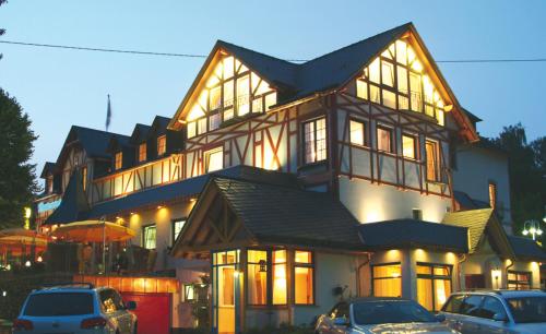 a large house with cars parked in front of it at Hotel Westerwälder Hof in Bad Marienberg