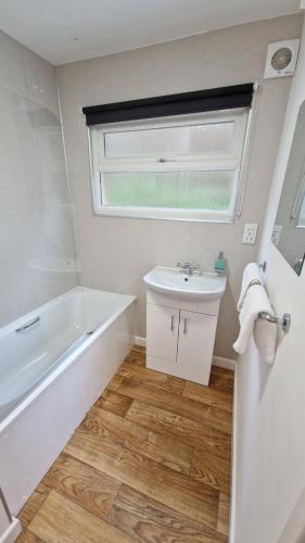 a bathroom with a sink and a bath tub and a sink at 6 The Dunes in Braunton