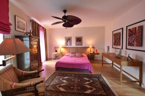 a bedroom with a bed and a ceiling fan at Domaine Panciarella in Saint-Florent