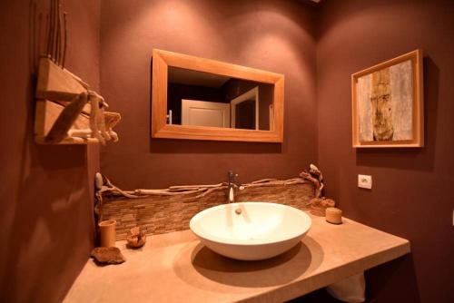 a bathroom with a white sink and a mirror at Domaine Panciarella in Saint-Florent