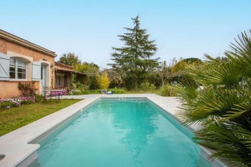 a swimming pool in the yard of a house at Studio 404 in Le Muy