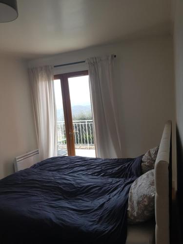 a bedroom with a bed and a window with a view at Villa mit großartigem Panoramablick auf das Meer und direkt am Pool in La Croix-Valmer