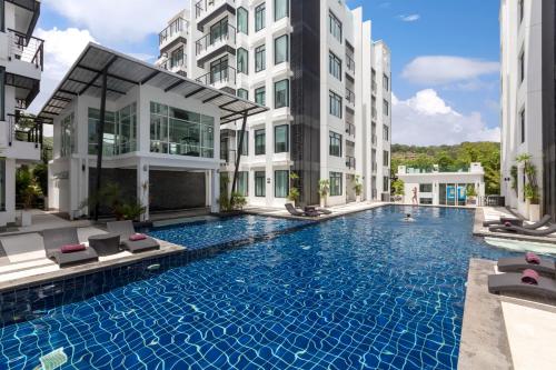 a swimming pool in the middle of a building at Kamala Regent Phuket Condotel in Kamala Beach