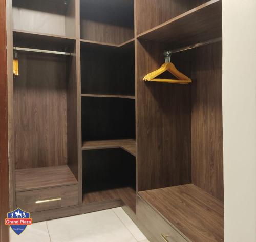 a walk in closet with wood paneling at Grand Plaza Sheikh Zayed in Kafr Abū ʼumaydah