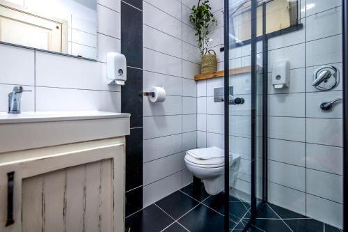 a bathroom with a toilet and a sink at כפר הנופש קיבוץ גדות Kibbutz Gadot Galilean Resort in Gadot