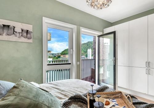 a bedroom with a bed and a view of a balcony at Seaside apt - 2 sunny balconies - Modern - 5 pax in Oslo