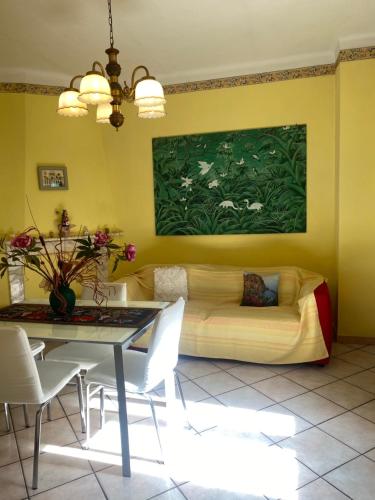 a living room with a couch and a table at Casa I Girasoli in Vezzano Ligure