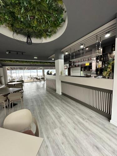 a restaurant with a table and chairs and a bar at Melin Residence in Orşova