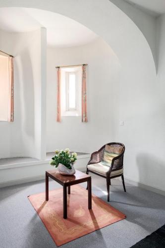 a living room with a table and a chair at Enjoy spring at Chateau de Monbrison, apartment for four guests in Saint-Michel
