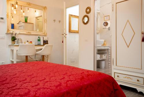 a bedroom with a red bed and a bathroom at CàPatron in Venice