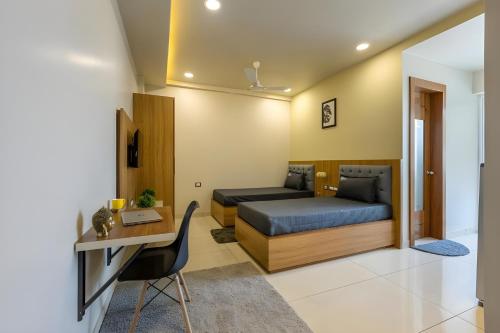 a bedroom with a bed and a desk and a desk at Wandr Lepus- Sector 39, Near Medicity Medanta in Gurgaon