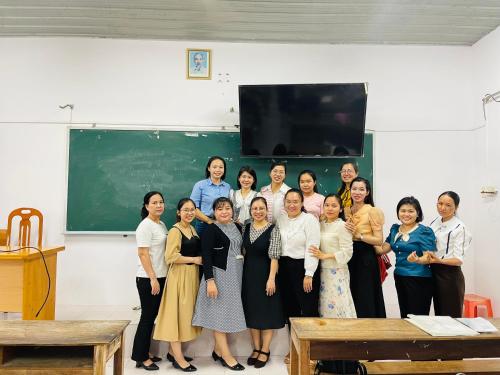 a group of women standing in front of a classroom at Phúc Nguyễn House in Lagi