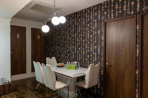 a dining room with a table and chairs at Elena Premium Namba Stay in Osaka