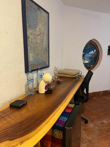 a wooden desk with a picture on the wall at Casa Cenote Hotel in Tankah