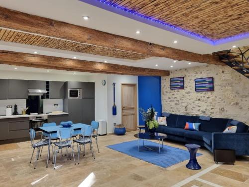 un salon avec un canapé bleu et une table dans l'établissement Domaine de la Tapie de Bouchet - en Camargue, à Arles
