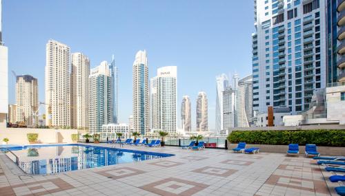 a pool in the middle of a city with tall buildings at Stylish 2BD with great view in Marina View Tower in Dubai