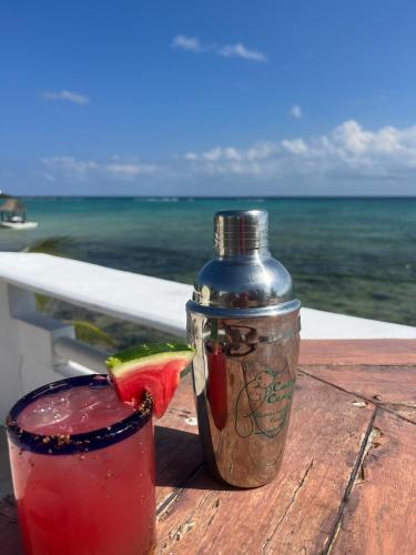 a drink and a jar with a slice of watermelon at Casa Cenote Hotel in Tankah