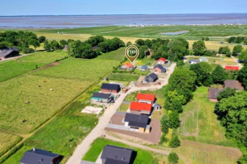 an aerial view of a farm with a large circle at Gemütliches Ferienhaus mit Pool DIREKT am Deich an der Nordsee, Nähe Center Parks in Sehestedt
