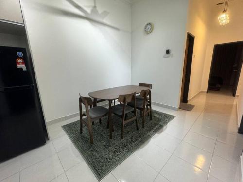 a dining room with a table and some chairs at Hazzani Homestay KLIA in Banting