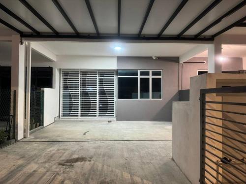 an empty room with a garage with a large window at Hazzani Homestay KLIA in Banting