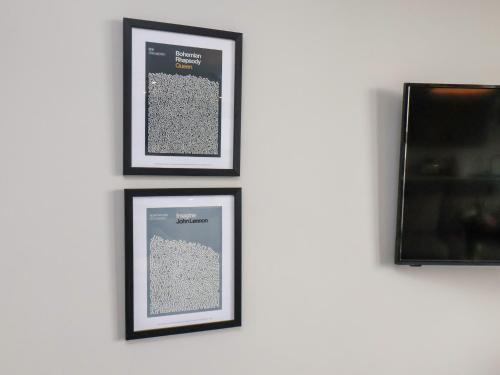 three framed pictures on a wall with a television at Apt 3 Hunter's Quay in Bridlington