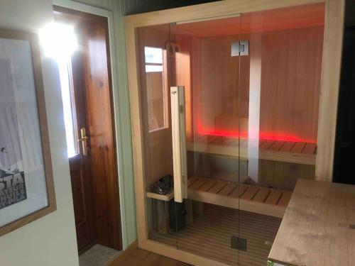 a glass shower in a room with a light at Chalet charme vista panoramica sauna idromassaggio (Chalet Fanella) in Valtournenche