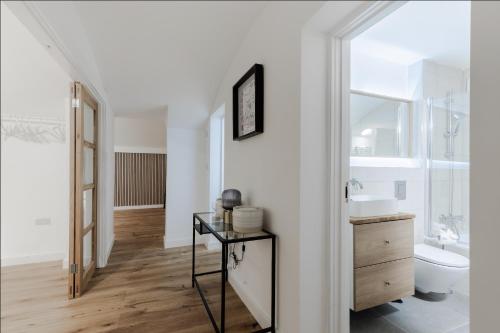 a white bathroom with a sink and a toilet at Sunlit Family Home in Hampstead in London