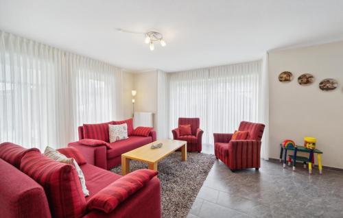 a living room with red couches and chairs at 3 Bedroom Stunning Home In Haren Ems in Dankern