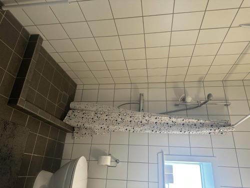 a bathroom with a shower and a shelf on the wall at Captivating 2-Bed Apartment in Viby J in Viby
