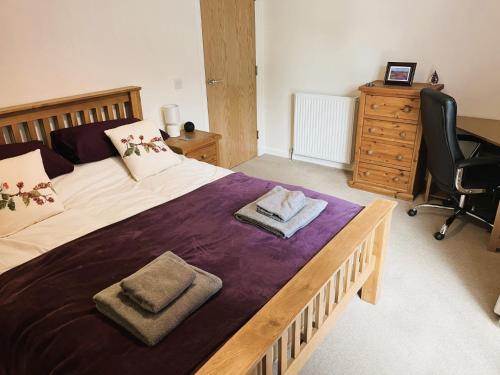 a bedroom with a large bed with two towels on it at Entire flat in Banchory, Aberdeenshire, Scotland in Banchory