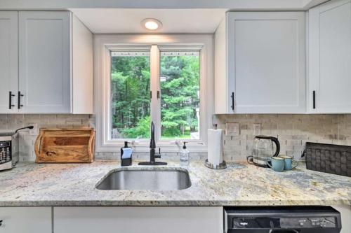 a kitchen counter with a sink and a window at Oasis Hot Tub Pool Game Room in Saylorsburg