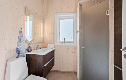 a bathroom with a sink and a toilet and a window at Nice Home In Humble With Kitchen in Humble