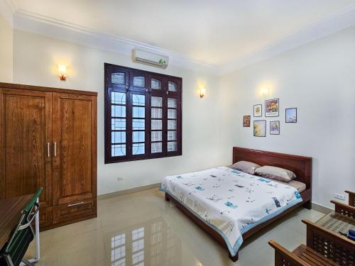 a bedroom with a bed and a window at Hanoi Delight House in Hanoi