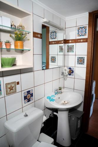 a bathroom with a toilet and a sink at Artistic 2 Apartment in Afitos